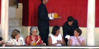 Arriba, camareros privados sirviendo bebidas a los maestrantes en vasos de cristal. Abajo, la seguridad de la plaza obliga a una joven a volcar el contenido de las latas a botellas de plástico y sin tapón para poder acceder a la plaza. (FOTOS: Javier Martínez)